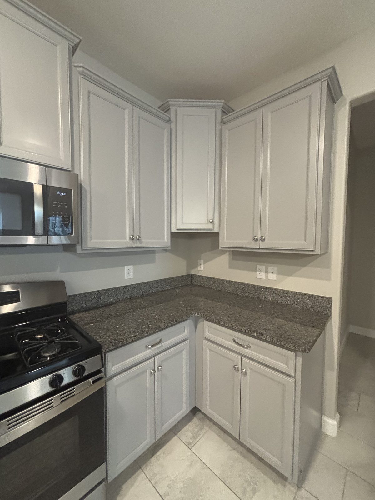Freshly refinished white shaker kitchen cabinets in a Tampa, Florida home